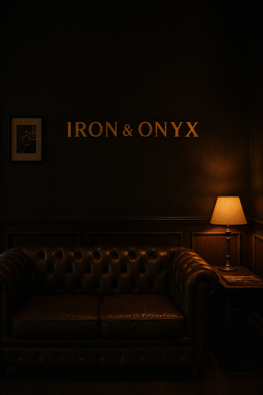 A tufted leather sofa beneath the Iron and Onyx wall sign